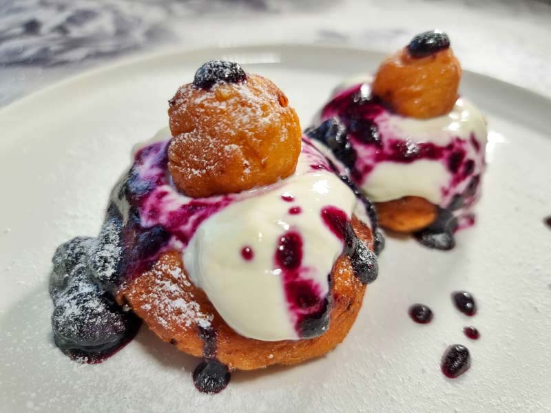 Papanași from Romania and Moldova is a fried doughnut filled with cheese